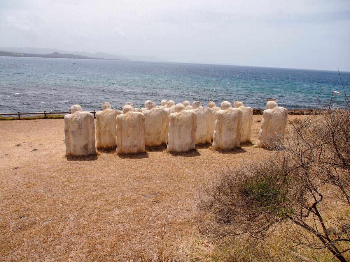 Heads bowed, staring out to sea: Anse Cafard Slave Memorial, Martinique | SBPR