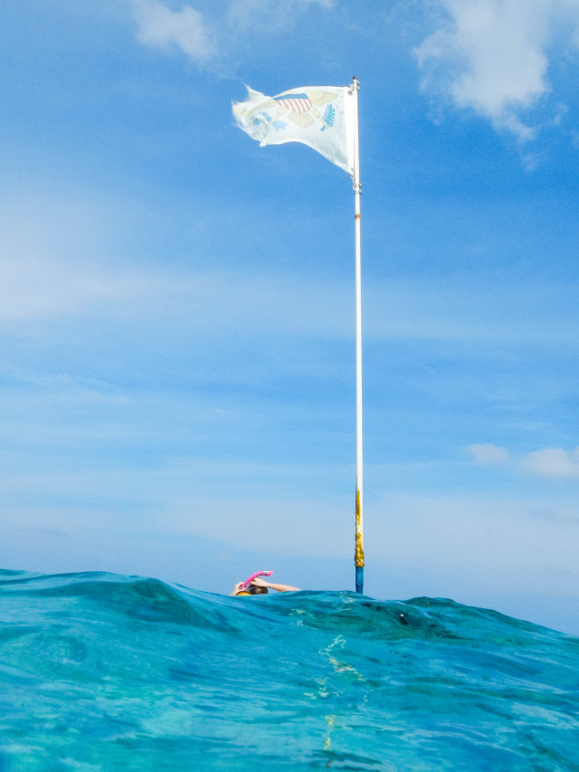 USVI flag above the waves by Patrick Bennett