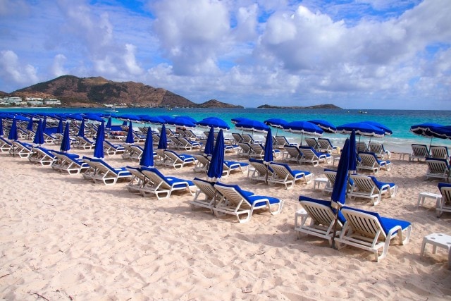An endless sea of blue chairs on Orient Bay, St. Martin | SBPR