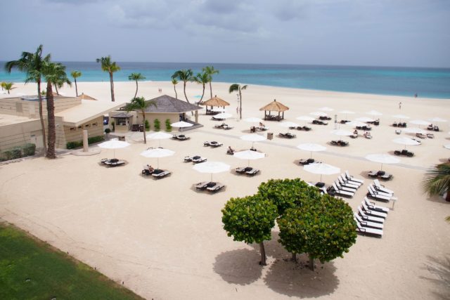 Bucuti and Tara Beach Resort's white umbrellas. Can you spot the one blue one..? | SBPR