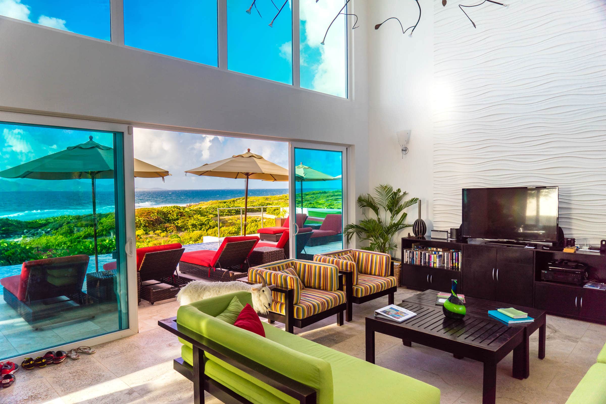 The main living area is a spacious two-story area made more perfect when the doors are opened to welcome the sea breeze.
