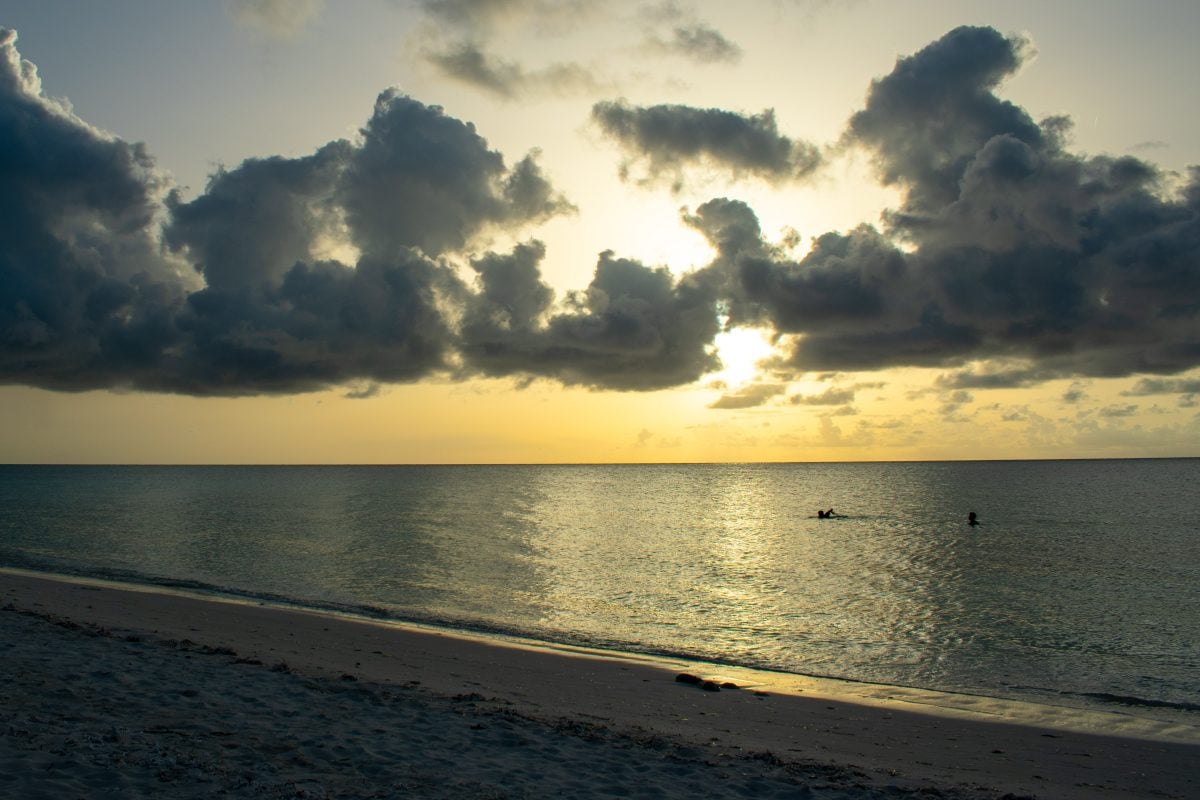 Swimming beneath the setting sun at Sandy Point Beach in North Caicos | SBPR